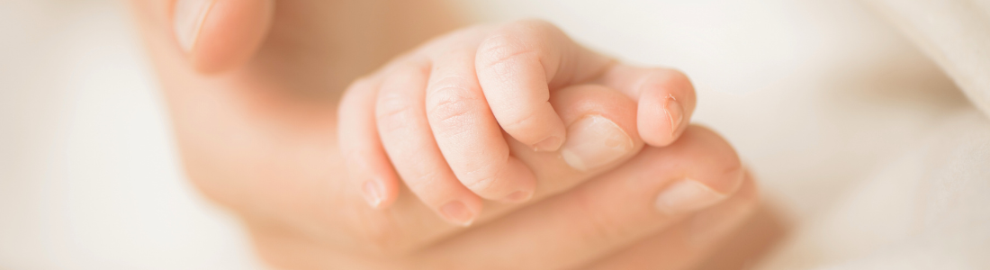 Baby holding finger