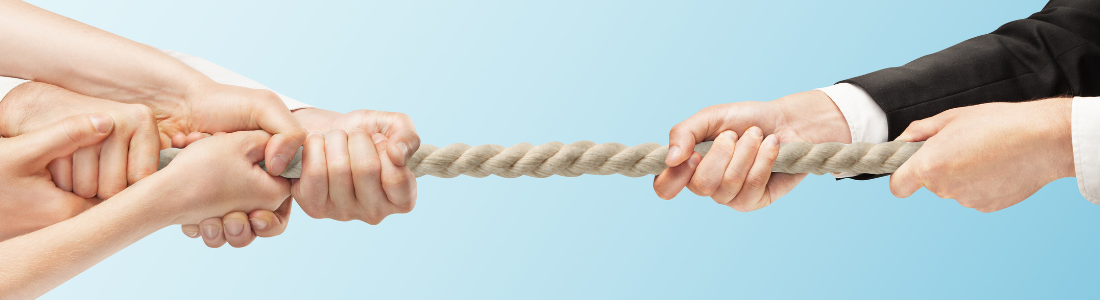 Tug-of-war with several hand at one end of the rope and one pair of hands at the other