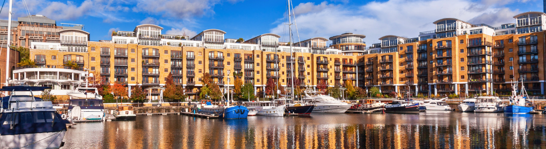 Waterside apartments witth boats in foreground