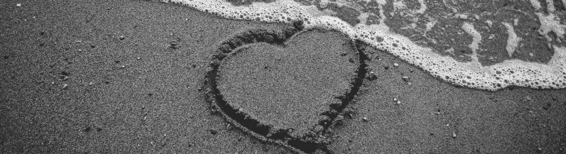 Heart in the sand washing away