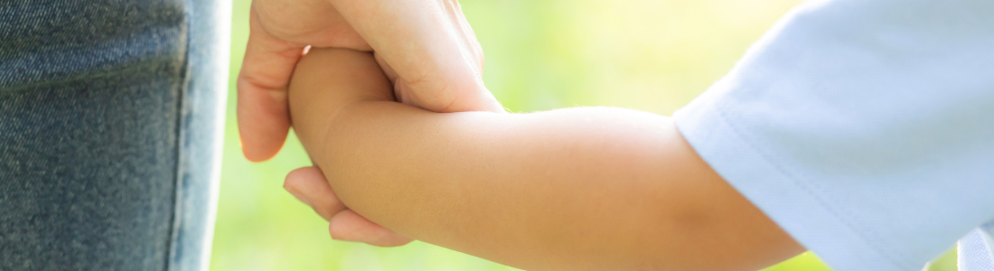 Child and parent holding hands