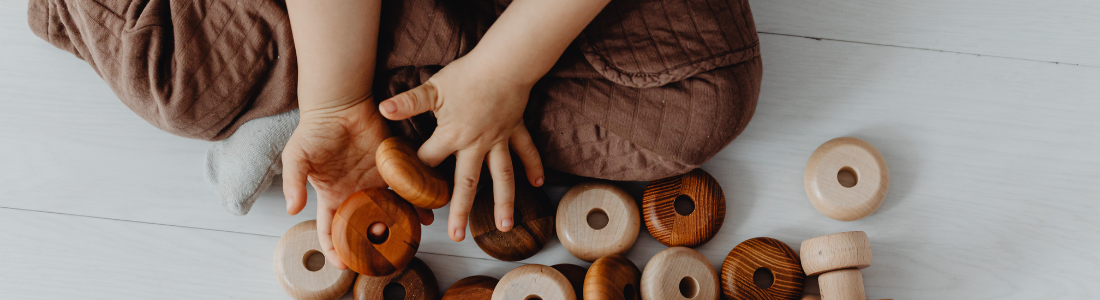 Child playing with wooden toy