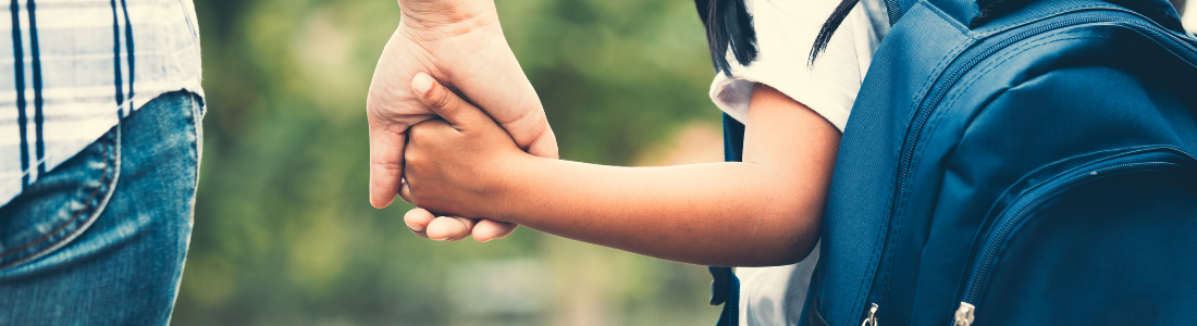 Parent holding child's hand