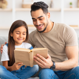 Bird nesting Dad listening to daughter read at home