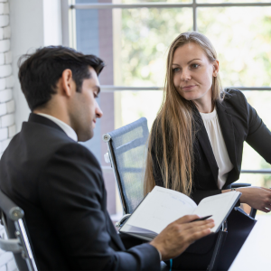 Man and woman in business suits discussing the terms of their commercial lease