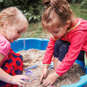 Children playing in a sandpit at home