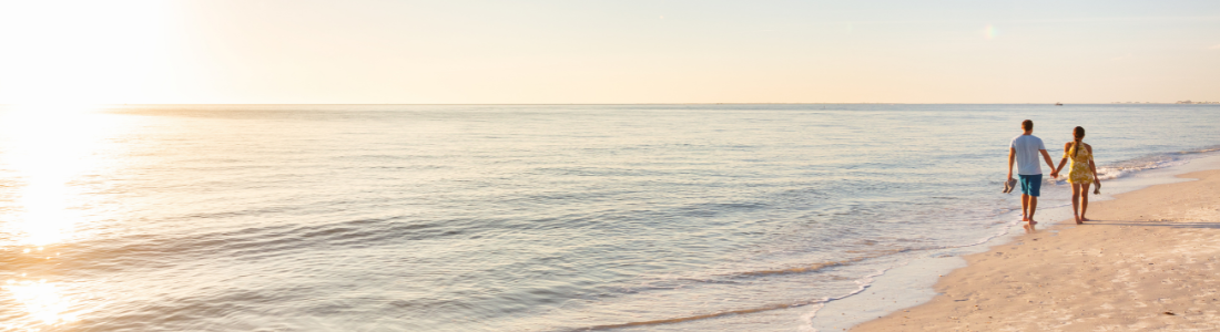 Couple strolling on beach following reconciliation agreement